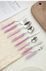 Detailed set of 304 stainless steel cutlery with unique purple bamboo handles on a placemat