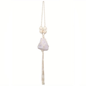 Detail of rose quartz crystal pendant with handmade woven net and wooden beads