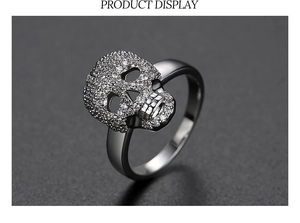 Macro shot of a silver gothic skull ring paved with sparkling white cubic zirconia stones