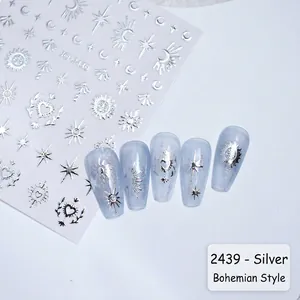 Macro detail of silver bohemian star and moon nail stickers for cosmic manicure art