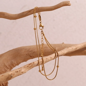 Detailed macro view of 18K gold plated double-layer snake chain with round beads