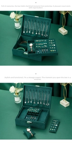 Deep green velvet jewelry box detail showing necklace hooks and multi-layer compartments