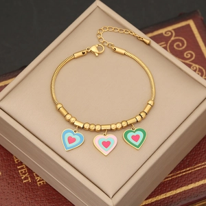Gold snake chain bracelet featuring blue, pink, and green enamel heart pendants