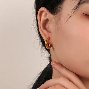 Elegant chunky gold hoop earrings for women featuring a minimalist thick round design