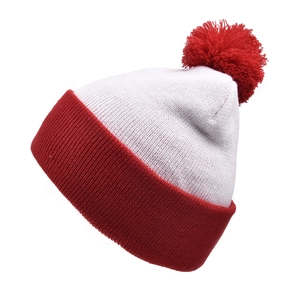 Close-up of winter knit beanie with soft red pom-pom and thick ribbed texture cuff