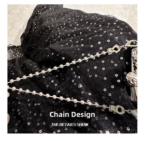 Detailed macro view of the silver metal spherical chain and clasp on this fashion bag