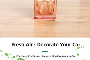 Close-up of pink glass car perfume bottle with wooden reeds on a warm wooden surface