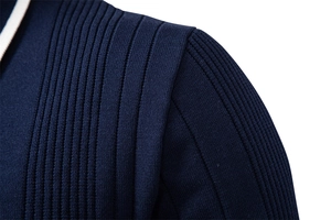 Close-up of shoulder stitching and vertical knit texture on dark blue polo sweater