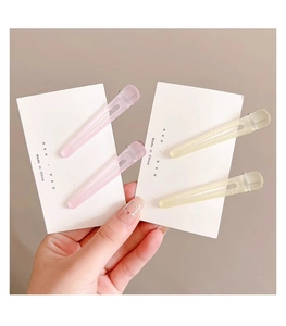 Frosted pastel pink and yellow hair clips displayed on cards for volume and styling