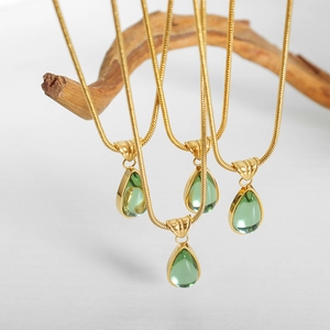 Vintage French gold snake chain necklace featuring elegant green teardrop crystal pendants