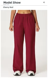 Detailed texture of cherry red high-waist joggers with wide elastic waistband