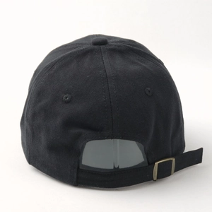 Detail view of the black cotton baseball cap back with bronze adjustable metal buckle
