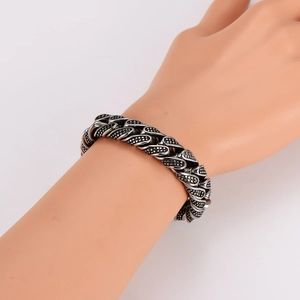 Vintage stainless steel Cuban link bracelet with black dots worn on a female wrist