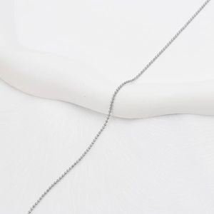 Gros plan d'un collier chaîne à billes en métal argenté avec un design poli épuré