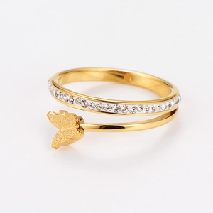 Macro shot of double-layered gold butterfly ring with micro-pave crystals and matte finish