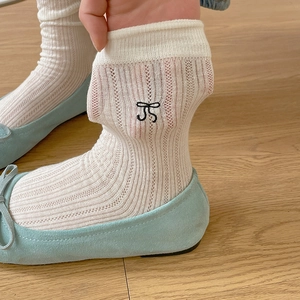 White cotton mesh socks with black bow embroidery and vertical striped knit texture