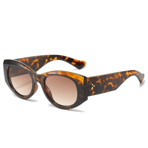 Retro oval tortoiseshell cat-eye sunglasses with gradient brown lenses and metal rivets