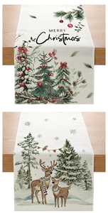 Detail of linen Christmas table runners with festive trees and reindeer on wooden table
