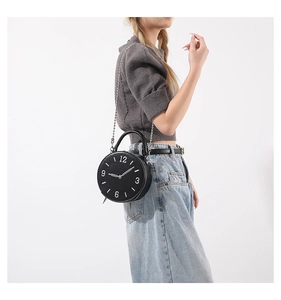 Creative clock-shaped handbag in black leather with white dial details and silver chain strap