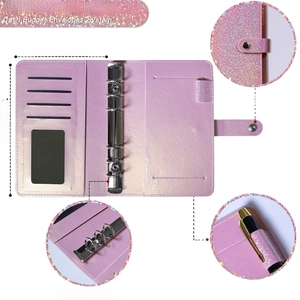 A6 pink glitter binder cover with 6-ring metal clips and elastic pen loop detail