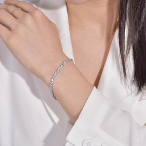 Elegant silver tennis bracelet with white zircon stones worn on a model wrist
