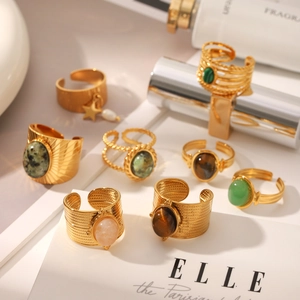 Detailed view of vintage gold stainless steel rings featuring natural tiger eye and turquoise stones