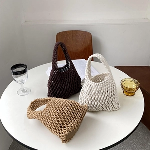 Three handmade cotton rope woven tote bags in brown, beige and khaki on a white table