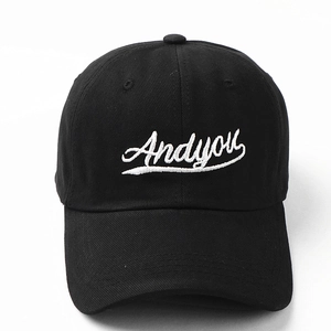 Close-up of a black cotton baseball cap featuring white 'Andyou' script embroidery detail