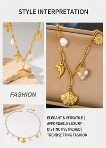 Detail of gold paperclip chain necklace with pearl, dolphin, and cross charms