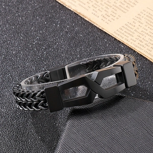 Detail shot of men's leather and black titanium steel link bracelet with geometric clasp