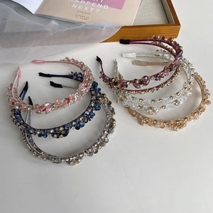 Detailed cluster of woven crystal beads and pearls on elegant handmade headbands