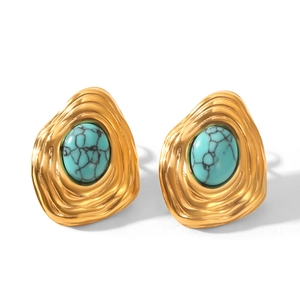 Detail of vintage gold earrings with turquoise stone inlays on a clean white background