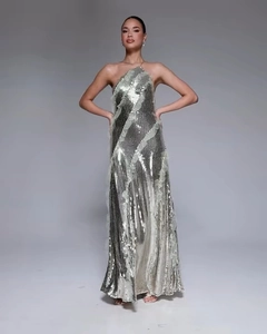 Detailed view of silver sequin fabric and pleated texture on long evening dress
