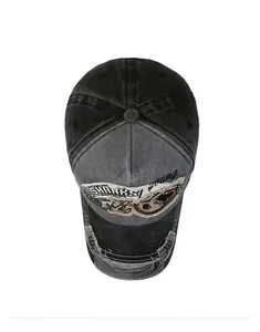 Detail view of the embroidered shark pattern and washed fabric on a vintage baseball cap