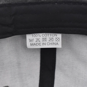 Detail of the internal cotton sweatband and 100% cotton wash label on a camo baseball cap