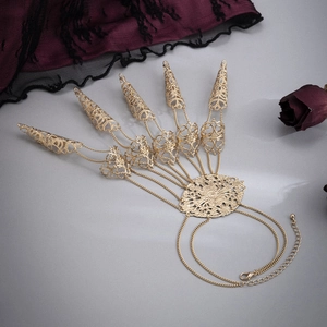 Gothic gold finger claw bracelet with hollow floral pattern and cone tassel detail