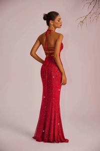 Detail of red sequin evening dress featuring backless design with elegant lace-up ties