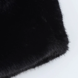 Macro close-up showing the rich texture and glossy finish of the premium black faux fur detail