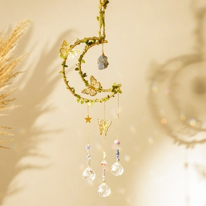 Detail of moon-shaped wind chime with butterflies, crystals, and natural blue raw stones