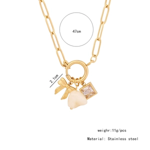 Detail of gold stainless steel paperclip necklace with bow and heart charms, 47cm length