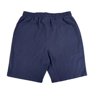 Detail of dark blue cotton linen men's shorts showing fabric texture and elastic waistband