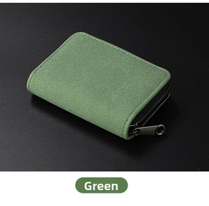Close-up of green frosted leather card wallet with white stitching and metal zipper detail