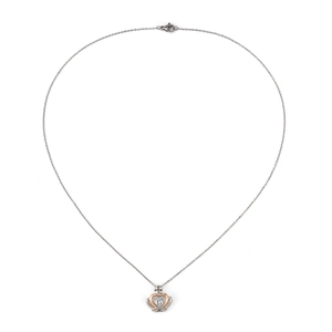 Close-up of heart-shaped crown pendant with two-tone finish and clear central stone