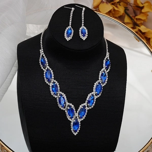 Detail of luxury bridal jewelry set featuring royal blue marquise crystals and silver finish