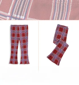 Close-up of red and blue plaid flared leggings with ribbed texture and ruffle hem