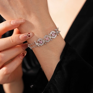 Detail of vintage silver bracelet with pink square zircon and crystal stones on wrist