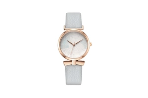 Detail of rose gold watch case featuring a white dial with delicate light blue leaf patterns