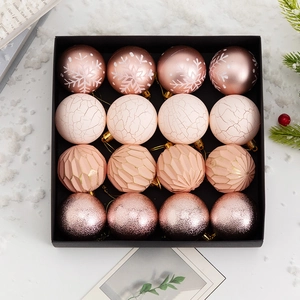 Pink and rose gold Christmas ball set with snowflake patterns and glitter texture in gift box