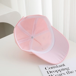 Detailed interior of a pink cotton kids baseball cap with sweatband and reinforced stitching