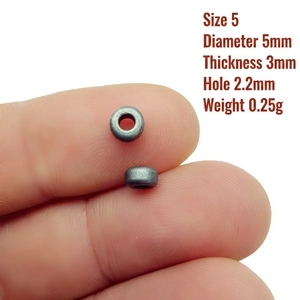 Macro shot of a 5mm metallic spacer bead for DIY jewelry making with exact dimensions